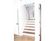 Foyer features staircase with wood steps and tile floor with white front door and sidelights at 1630 Versailles Dr, Atlanta, GA 30331