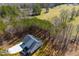 A peaceful modern farmhouse is nestled amongst a dense forest and features a long driveway at 279 Laura Cir, Bowdon, GA 30108