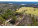 Expansive aerial view of property with lush greenery, trees, and meadows in a serene, countryside setting at 279 Laura Cir, Bowdon, GA 30108