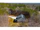 Aerial view of a modern farmhouse nestled amongst a dense forest at 279 Laura Cir, Bowdon, GA 30108