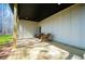 Back porch with wooden chairs, a dark ceiling and green lawn at 279 Laura Cir, Bowdon, GA 30108