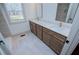 Elegant bathroom featuring a double vanity with marble countertop, stylish fixtures, and natural light from the window at 279 Laura Cir, Bowdon, GA 30108