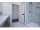 Modern bathroom featuring a tiled shower with a built-in niche, sleek fixtures, and a frameless glass door at 279 Laura Cir, Bowdon, GA 30108