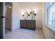 Bathroom with dual vanity, undermount sinks, tile flooring, and natural light from window at 279 Laura Cir, Bowdon, GA 30108