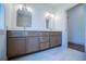 Bathroom featuring a double vanity with modern fixtures and decorative mirrors, complemented by neutral tones at 279 Laura Cir, Bowdon, GA 30108