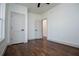 Spacious bedroom with hardwood floors, ceiling fan, and two doors at 279 Laura Cir, Bowdon, GA 30108