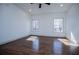 Sunlit bedroom featuring hardwood floors and windows offering picturesque views of the surrounding trees at 279 Laura Cir, Bowdon, GA 30108