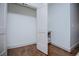 White closet with an open door and a built-in shelf creating an organized space and hardwood floors at 279 Laura Cir, Bowdon, GA 30108