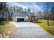 Wide driveway to a modern farmhouse-style home with an attached garage at 279 Laura Cir, Bowdon, GA 30108