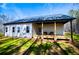 Exterior of home with a porch, a lawn, and wooded area at 279 Laura Cir, Bowdon, GA 30108