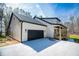 Modern two-story home with a two-car garage, black trim, and a cozy covered porch at 279 Laura Cir, Bowdon, GA 30108