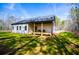Charming single-story home featuring a spacious porch perfect for relaxing in a serene, wooded setting at 279 Laura Cir, Bowdon, GA 30108