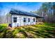 Exterior of home with a porch, a lawn, and wooded area at 279 Laura Cir, Bowdon, GA 30108