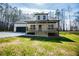 Lovely home with a covered front porch and an attached garage, set against a backdrop of tall trees at 279 Laura Cir, Bowdon, GA 30108