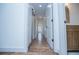 Hallway with white doors, hardwood floors, and natural light; creates a bright and inviting path at 279 Laura Cir, Bowdon, GA 30108