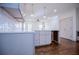 A modern kitchen island features white cabinets, a white countertop, stainless steel faucet, and hardwood flooring at 279 Laura Cir, Bowdon, GA 30108
