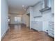 Well-lit kitchen with white cabinets, stainless steel hood, hardwood floors and an adjacent dining area with a window at 279 Laura Cir, Bowdon, GA 30108