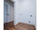 Bright laundry room with hardwood floors and utility connections at 279 Laura Cir, Bowdon, GA 30108