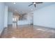 Open-concept living area with hardwood floors, ceiling fan, and bright, white walls at 279 Laura Cir, Bowdon, GA 30108