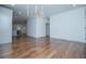 Spacious living room with hardwood floors, modern chandelier, and view into the open kitchen at 279 Laura Cir, Bowdon, GA 30108