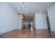 Open-concept living room with hardwood floors, modern chandelier, and a view of the kitchen at 279 Laura Cir, Bowdon, GA 30108
