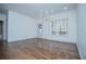 Bright living room with hardwood floors, chandelier, and large windows overlooking a wooded area at 279 Laura Cir, Bowdon, GA 30108