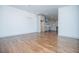 Open living room with hardwood floors and modern chandelier near the kitchen with gray cabinetry at 279 Laura Cir, Bowdon, GA 30108