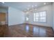 Bright living room with hardwood floors, chandelier, and large windows overlooking a wooded area at 279 Laura Cir, Bowdon, GA 30108
