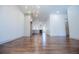 Open-concept living room with hardwood floors, modern chandelier, and a view of the kitchen at 279 Laura Cir, Bowdon, GA 30108