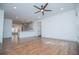 Open-concept living area with hardwood floors, ceiling fan, and bright, white walls at 279 Laura Cir, Bowdon, GA 30108