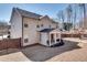 Well-maintained backyard boasts a covered patio, lush green space, and a wooden fence, creating a private oasis at 5242 Park Vale Dr, Sugar Hill, GA 30518