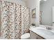 Cozy bathroom featuring a floral shower curtain and modern fixtures at 5242 Park Vale Dr, Sugar Hill, GA 30518