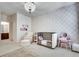 Charming Bedroom features a chandelier, patterned wallpaper, stylish furnishings, and plenty of room to grow at 5242 Park Vale Dr, Sugar Hill, GA 30518