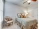 Neutral bedroom features a ceiling fan, bright window, chair and closet at 5242 Park Vale Dr, Sugar Hill, GA 30518