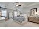 Relaxing main bedroom featuring tray ceilings, neutral colors, and lots of natural light at 5242 Park Vale Dr, Sugar Hill, GA 30518