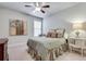 Cozy bedroom features a ceiling fan, neutral walls, and carpeted flooring at 5242 Park Vale Dr, Sugar Hill, GA 30518