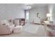 Bright Bedroom features a chandelier, classic furnishings, a plush armchair, and plenty of natural light at 5242 Park Vale Dr, Sugar Hill, GA 30518