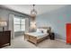 Stylish bedroom features textured blue walls, neutral carpet and stylish lighting at 5242 Park Vale Dr, Sugar Hill, GA 30518