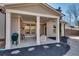 Inviting covered patio with brick fireplace, ceiling fans, and comfortable seating, perfect for relaxing outdoors at 5242 Park Vale Dr, Sugar Hill, GA 30518