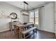 Charming dining area featuring hardwood floors, a rustic table with bench seating, and ample natural light at 5242 Park Vale Dr, Sugar Hill, GA 30518