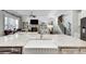 Open-concept kitchen with a granite island overlooking the living room featuring a fireplace and hardwood floors at 5242 Park Vale Dr, Sugar Hill, GA 30518