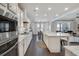 Modern kitchen with white cabinets, stainless steel appliances, and a spacious island at 5242 Park Vale Dr, Sugar Hill, GA 30518