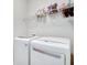 Bright laundry room with modern appliances and shelving at 5242 Park Vale Dr, Sugar Hill, GA 30518