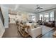 Open-concept living room features hardwood floors, white sofas, and a view of the gourmet kitchen at 5242 Park Vale Dr, Sugar Hill, GA 30518