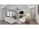 Bright and airy living room with a stone fireplace, built-in shelving, and hardwood floors at 5242 Park Vale Dr, Sugar Hill, GA 30518