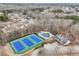 Aerial view shows tennis courts, community pool, and neighborhood at 520 Ballyshannon Dr, Dacula, GA 30019