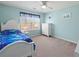 Light blue bedroom with a ceiling fan, a window, and carpet flooring at 520 Ballyshannon Dr, Dacula, GA 30019