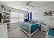 Bright bedroom with a ceiling fan, window and blinds, shelf, bed and a nightstand at 520 Ballyshannon Dr, Dacula, GA 30019