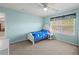 Bright bedroom features light blue walls, carpet flooring, and a ceiling fan at 520 Ballyshannon Dr, Dacula, GA 30019