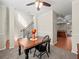 Dining room with a hardwood table and chairs, flowing into the kitchen and entryway at 520 Ballyshannon Dr, Dacula, GA 30019
